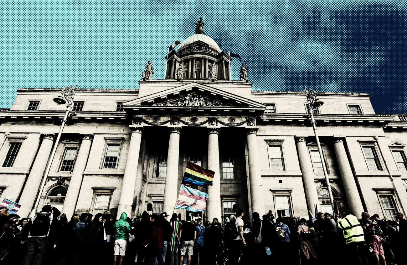 People protest with trans flags and signs